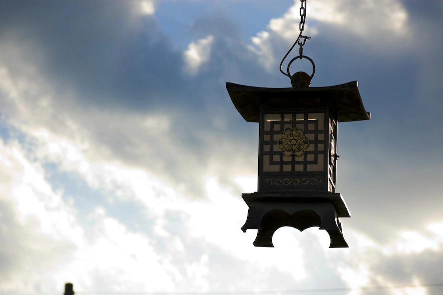 hanging-japanese-lantern-against-overcast-sky.webp