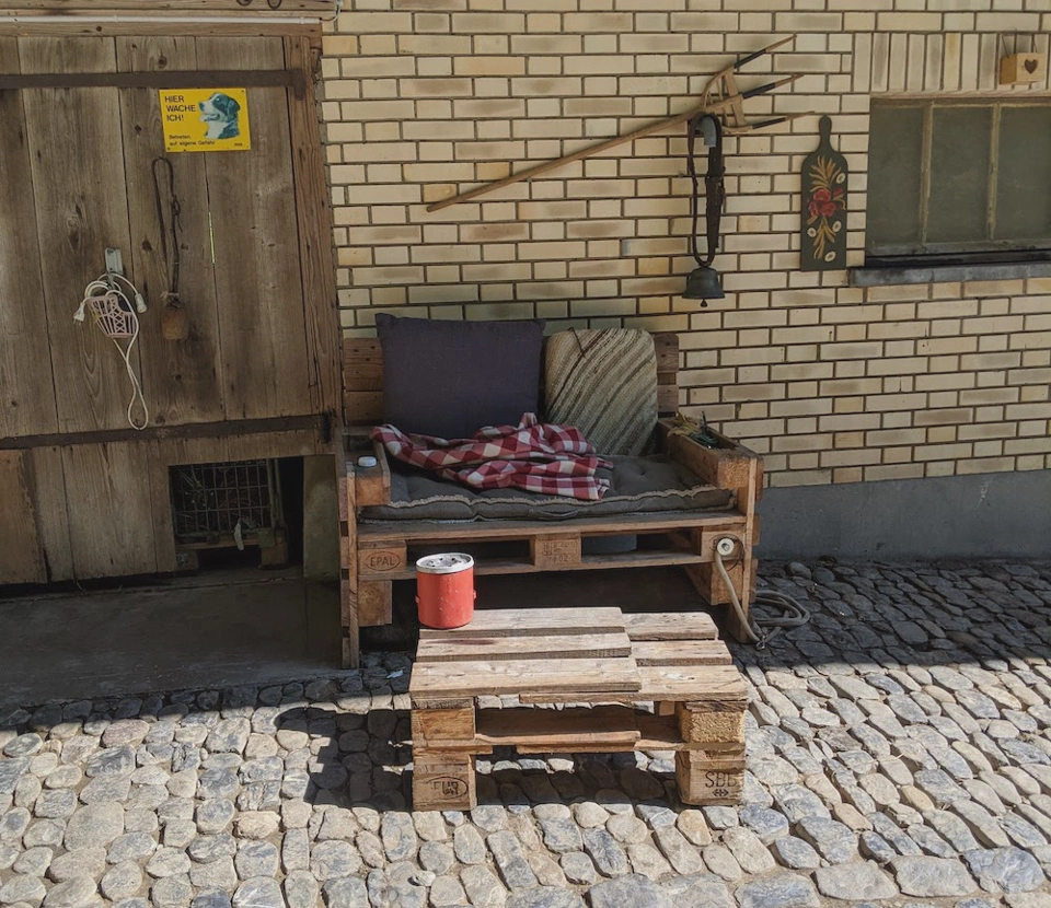 Sofa in front of a farm.